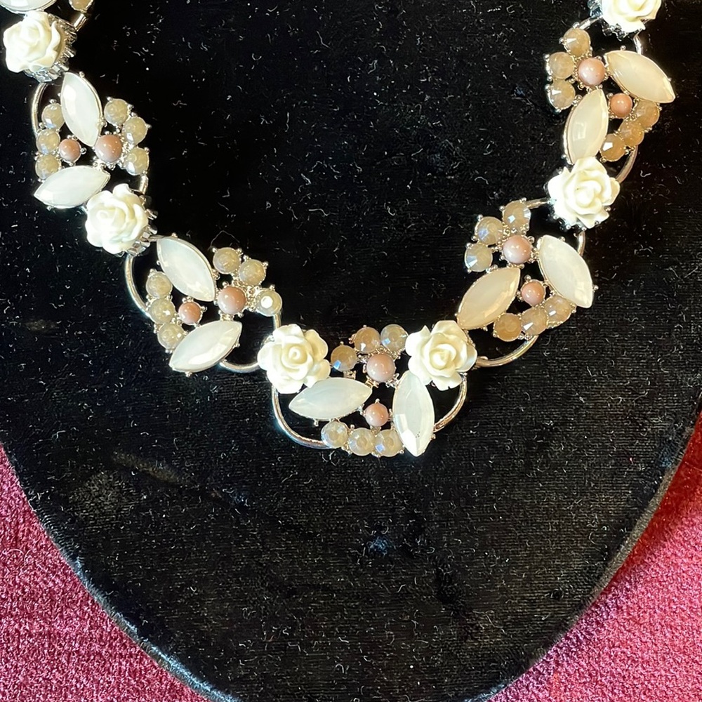 White rose and light brown and opal jewel detail around.